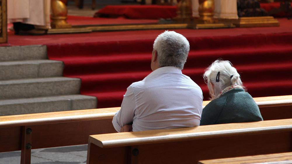 Seniorenpaar in einer Kirche.